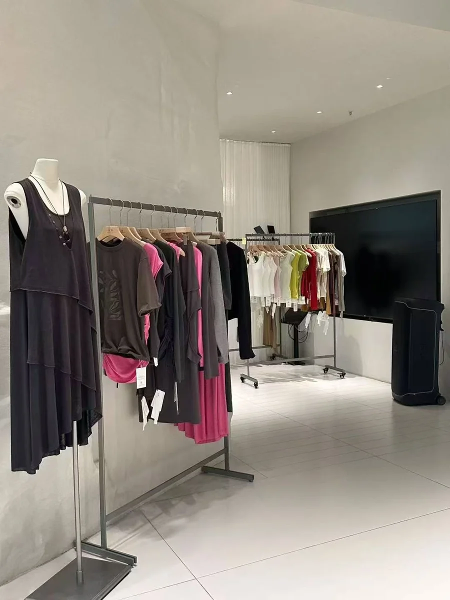 Garment display rails and a mannequin inside our showroom