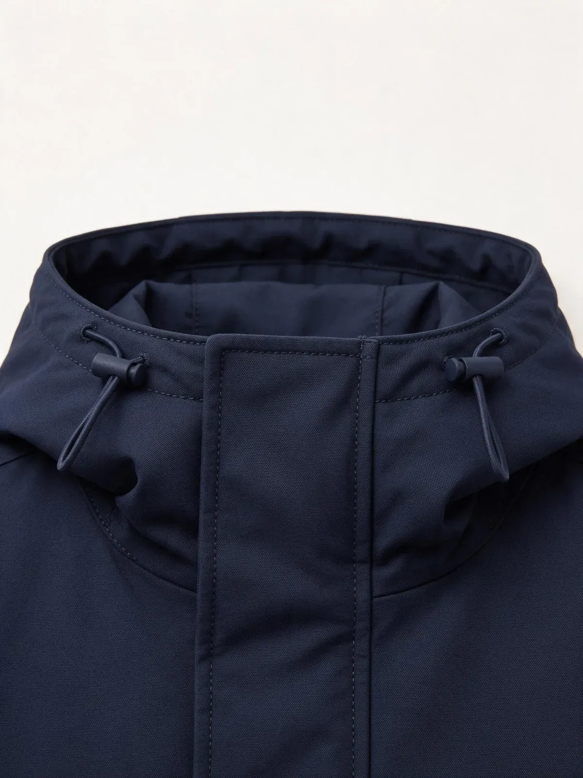 Navy jacket hood opening with drawcord adjusters and front placket.