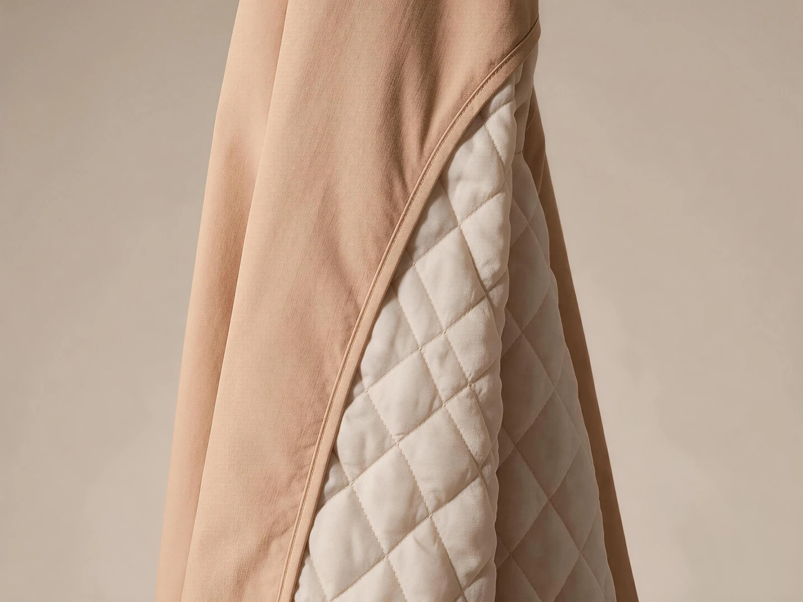 A light camel coat panel with an off-white diamond-quilted lining.