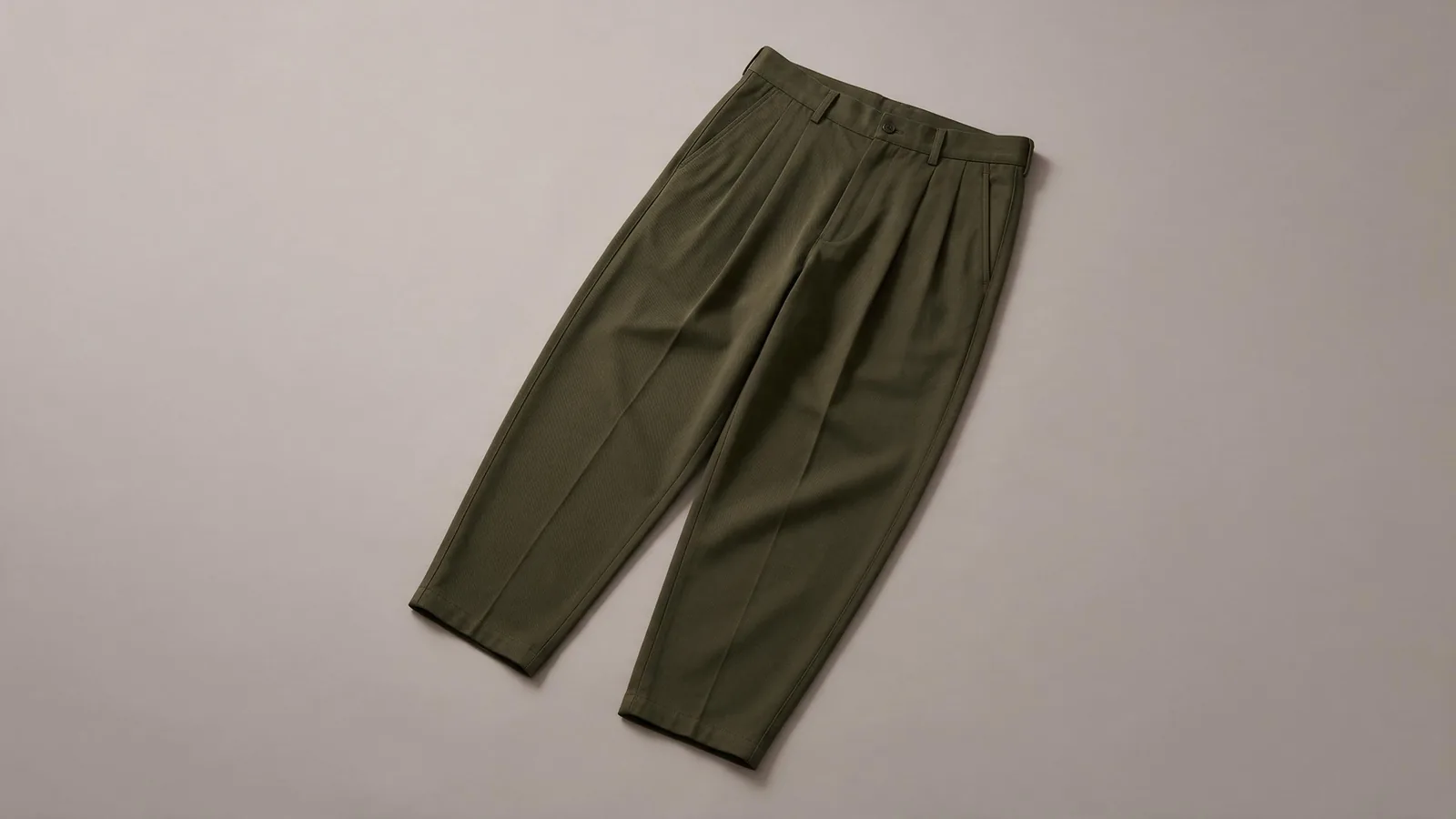 Dark olive trousers with front pleats and a smooth waistband.