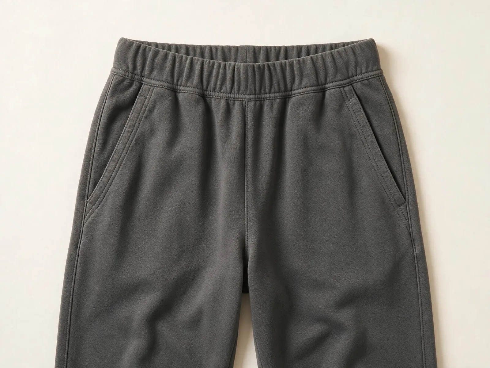 AI design concept showing charcoal pants with an elastic waistband and side pocket openings