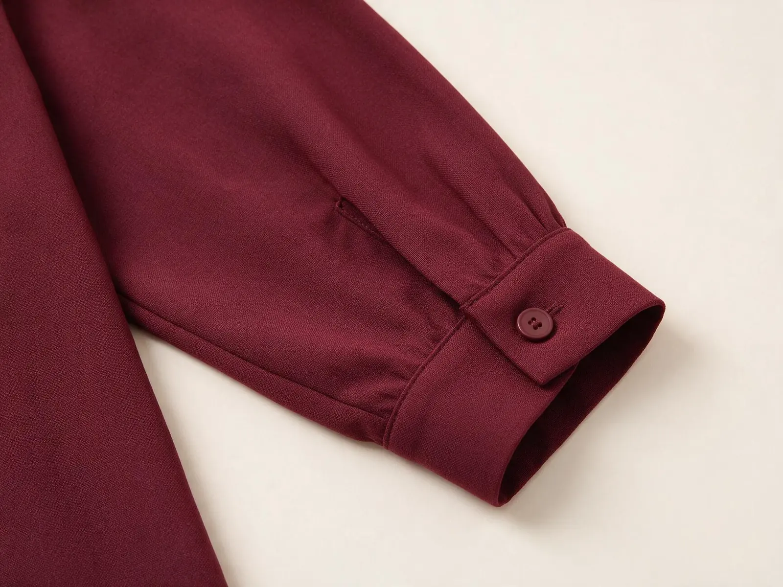 AI design concept showing a burgundy dress sleeve with a narrow single-button cuff
