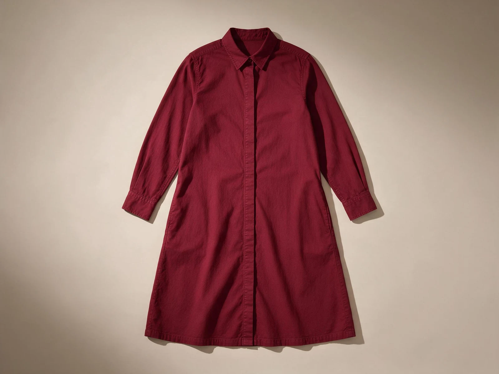 AI design concept of a wine-red long-sleeve shirt dress, viewed flat from the front with a pointed collar and button placket