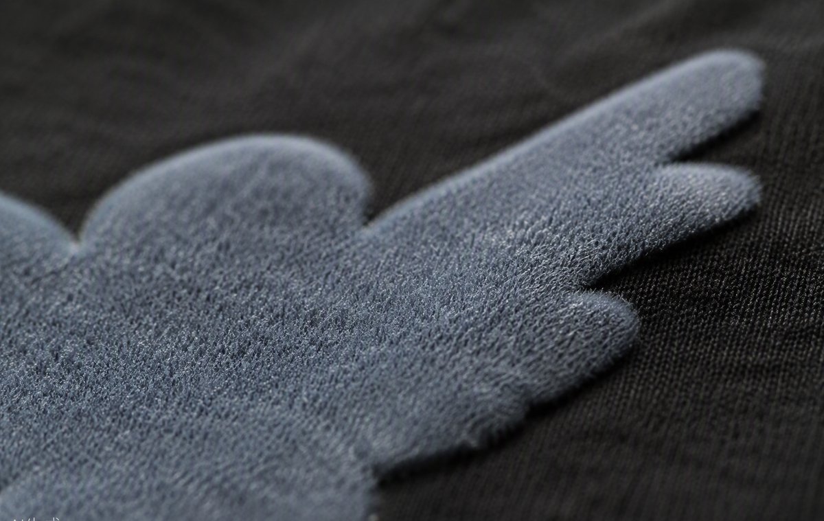 Close-up of velvet-texture flock print on a garment