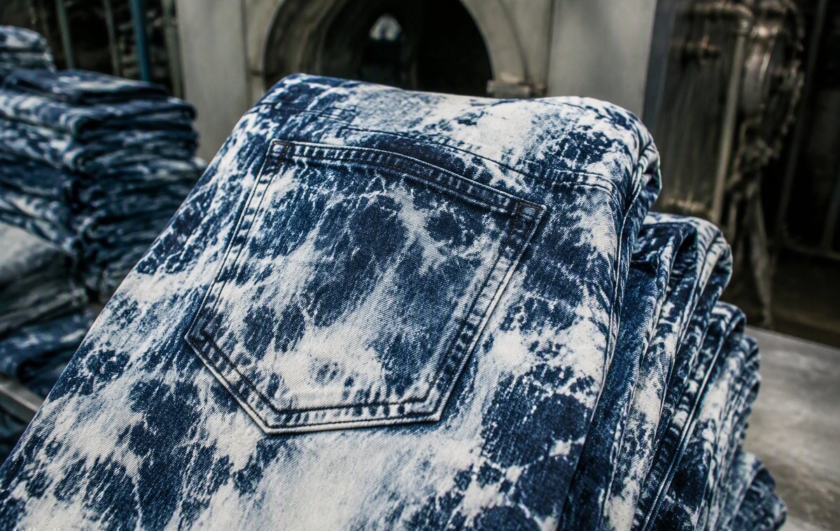 Garments with mottled acid wash pattern being processed